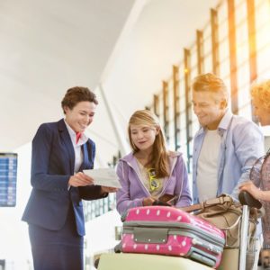 Family On Holiday Asking For Assistance With Airport Staff
