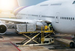 Ground crew loading dangerous goods onto airplane
